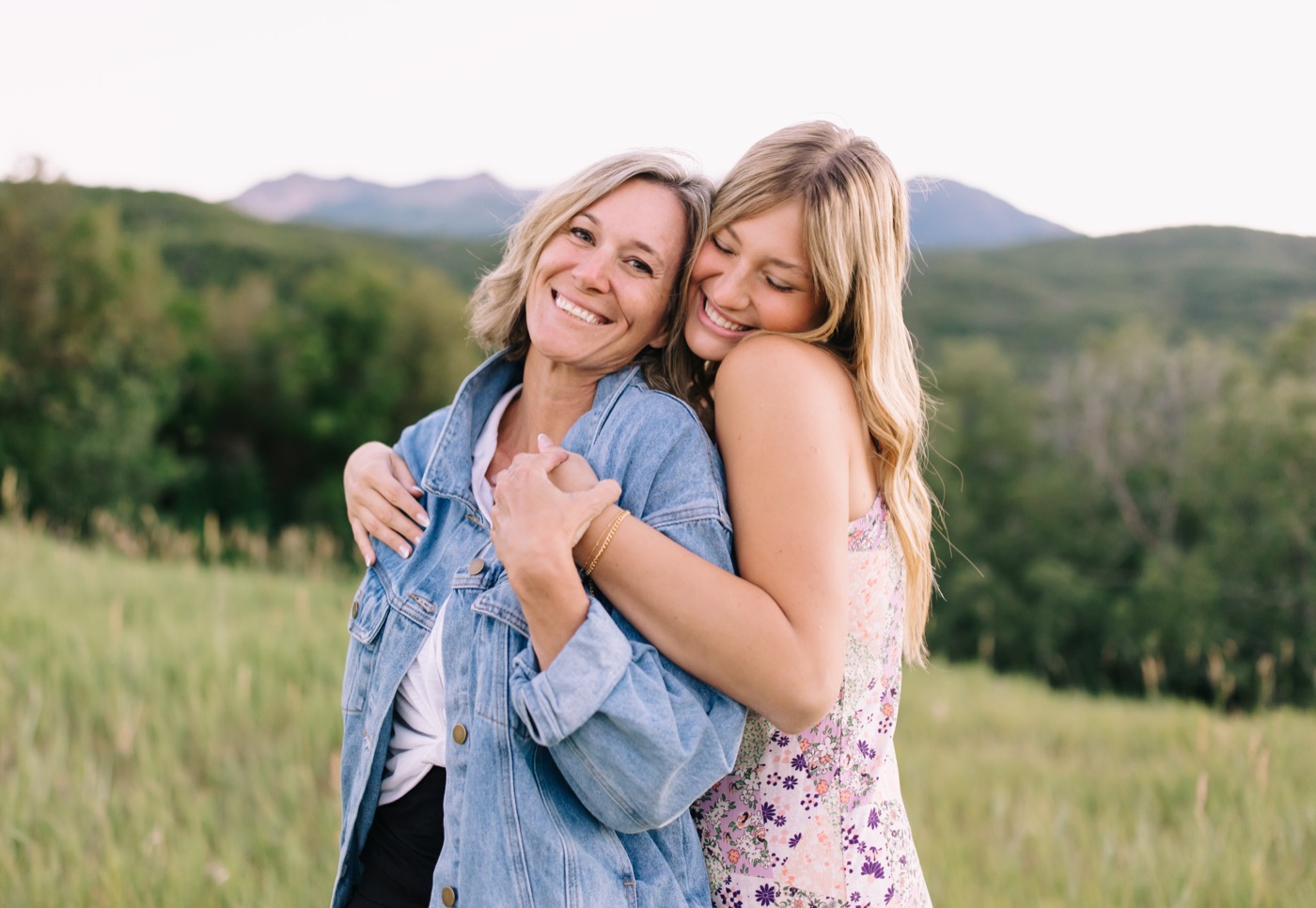 Harper hugging Niki in a mountain meadow